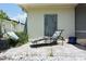 Outdoor seating area on a paver patio features a lounge chair and small plants for relaxing at 9003 Lido Ln, Port Richey, FL 34668