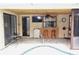 Inviting pool patio with tiled floor, bar seating, ceiling fan, and direct access to the pool at 9003 Lido Ln, Port Richey, FL 34668