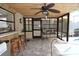 Screened lanai beside a pool with bar seating and a bamboo ceiling at 9003 Lido Ln, Port Richey, FL 34668