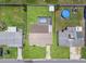 Aerial view of a home with a screened pool and fenced backyard at 9016 Unicorn Ave, Port Richey, FL 34668