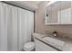 Bathroom with vanity, mirror, toilet and shower curtain creates a clean and functional space at 9016 Unicorn Ave, Port Richey, FL 34668