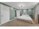 Calm bedroom featuring a soft carpet, a comfy bed, and two windows with natural light at 9016 Unicorn Ave, Port Richey, FL 34668