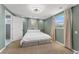 Serene bedroom with a plush bed, neutral carpet, and access to the bathroom at 9016 Unicorn Ave, Port Richey, FL 34668