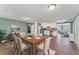 Open-concept dining space with wood-look flooring, connecting seamlessly to the kitchen and living room at 9016 Unicorn Ave, Port Richey, FL 34668