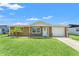 Charming single-story home with a well-manicured lawn and a cozy, covered front porch, inviting curb appeal at 9016 Unicorn Ave, Port Richey, FL 34668