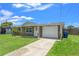 Charming single-story home with attached garage, bright lawn and walkway, and inviting curb appeal at 9016 Unicorn Ave, Port Richey, FL 34668