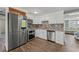 Modern kitchen with stainless steel appliances, granite countertops, and beautiful backsplash at 9016 Unicorn Ave, Port Richey, FL 34668