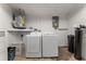 Bright laundry room with washer, dryer, and essential utilities ensures efficient and organized chore space at 9016 Unicorn Ave, Port Richey, FL 34668