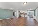 Open-concept living space with wood-look flooring, connecting seamlessly to the kitchen with stainless appliances at 9016 Unicorn Ave, Port Richey, FL 34668