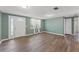 Inviting living room with ample natural light, wood-look flooring and neutral wall color at 9016 Unicorn Ave, Port Richey, FL 34668