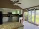Bright kitchen with white cabinets, stainless steel appliances, and tiled floors next to sunroom at 9155 Pemberton St, Spring Hill, FL 34608