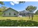 A fenced backyard features a screened in-ground pool and a grassy lawn at 9431 Amidon St, Spring Hill, FL 34608