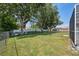 A fenced backyard features a grassy lawn with shade trees at 9431 Amidon St, Spring Hill, FL 34608