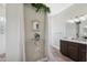 Bright bathroom showing wood look flooring, double vanity, walk-in shower and greenery at 9431 Amidon St, Spring Hill, FL 34608