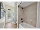 Bright bathroom with walk in shower and natural light from the pool patio door at 9431 Amidon St, Spring Hill, FL 34608