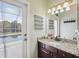 Bathroom with granite counters and a door to a patio with pool views at 9431 Amidon St, Spring Hill, FL 34608