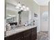 Bathroom with vanity and granite countertops, shower with glass block window and decorative tile at 9431 Amidon St, Spring Hill, FL 34608