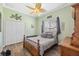 Cozy bedroom with wood floors, decorative ceiling fan and neutral green walls at 9431 Amidon St, Spring Hill, FL 34608