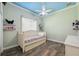 room with trundle bed, custom ceiling paint, and shelves to display their favorite toys at 9431 Amidon St, Spring Hill, FL 34608
