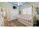 bedroom with trundle bed, wood-look floors, ceiling fan, and ample closet space at 9431 Amidon St, Spring Hill, FL 34608