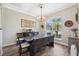 Bright dining room featuring hardwood floors, a window view and modern chandelier with decor at 9431 Amidon St, Spring Hill, FL 34608