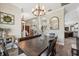 Dining room shows hardwood floors, view to living room and kitchen, and overhead lighting at 9431 Amidon St, Spring Hill, FL 34608
