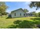 Home exterior features a grassy lawn, a fenced backyard and an in-ground screened pool at 9431 Amidon St, Spring Hill, FL 34608