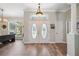 Bright foyer with decorative double doors, wood floors, and a view to the adjacent living area at 9431 Amidon St, Spring Hill, FL 34608