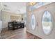 Inviting foyer with decorative glass double doors leads to the dining area with hardwood floors and chandelier at 9431 Amidon St, Spring Hill, FL 34608