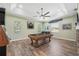 Large game room featuring tray ceilings, hardwood floors, ceiling fan, a pool table, and natural light at 9431 Amidon St, Spring Hill, FL 34608