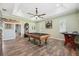 Game room with tile floors, tray ceilings, ceiling fan, and a pool table at 9431 Amidon St, Spring Hill, FL 34608