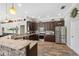 Spacious kitchen features stone countertop, hardwood floors, stainless appliances and dark wood cabinets at 9431 Amidon St, Spring Hill, FL 34608