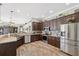Gourmet kitchen featuring stone countertops, stainless appliances and hardwood floors at 9431 Amidon St, Spring Hill, FL 34608