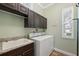 Functional laundry room with convenient sink, washer and dryer at 9431 Amidon St, Spring Hill, FL 34608