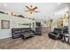 Spacious living room featuring a stone bar, hardwood floors, ceiling fan, and open floor plan at 9431 Amidon St, Spring Hill, FL 34608