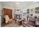 Comfortable living room with fireplace, wood-look floors, and rustic decor at 9431 Amidon St, Spring Hill, FL 34608