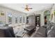 Spacious living room featuring hardwood floors, sliding glass doors to the lanai and modern decor at 9431 Amidon St, Spring Hill, FL 34608