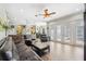 Open-concept living room featuring a stone bar, tile floors, ceiling fan, and access to the pool at 9431 Amidon St, Spring Hill, FL 34608