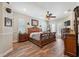 Bedroom with hardwood floors, ceiling fan, and French doors to the outside at 9431 Amidon St, Spring Hill, FL 34608