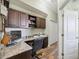 Office with built-in desk, cabinets, white trim and wood-look floors at 9431 Amidon St, Spring Hill, FL 34608