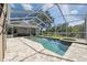 A beautiful screened pool area boasts an in-ground spa, deck and sitting area at 9431 Amidon St, Spring Hill, FL 34608