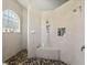 Bright shower with tiled seat, niche, pebble tile floor, and glass block window at 9431 Amidon St, Spring Hill, FL 34608