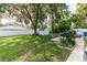 A spacious, fenced backyard, with mature trees, a shed, and a patio area at 9630 Eldridge Rd, Spring Hill, FL 34608