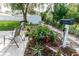 Landscaped backyard with patio seating, lush greenery, and a garden shed for extra storage at 9630 Eldridge Rd, Spring Hill, FL 34608