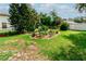 A landscaped garden bed is the centerpiece of this expansive backyard at 9630 Eldridge Rd, Spring Hill, FL 34608