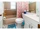 Compact bathroom with a tub/shower combo, grab bars, and a white vanity at 9630 Eldridge Rd, Spring Hill, FL 34608