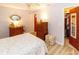 Bedroom featuring a comfortable bed, wood-look floors, dresser, and a walk-in closet at 9630 Eldridge Rd, Spring Hill, FL 34608