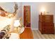 Bedroom leading into bathroom with wood-look floors, decorative mirror and dresser at 9630 Eldridge Rd, Spring Hill, FL 34608
