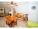 Bright dining space offering neutral walls, wood floors and ceilings, adjoining the living area at 9630 Eldridge Rd, Spring Hill, FL 34608