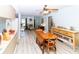 Spacious dining area with wood floors, wooden dining table, seamlessly connected to the living areas at 9630 Eldridge Rd, Spring Hill, FL 34608